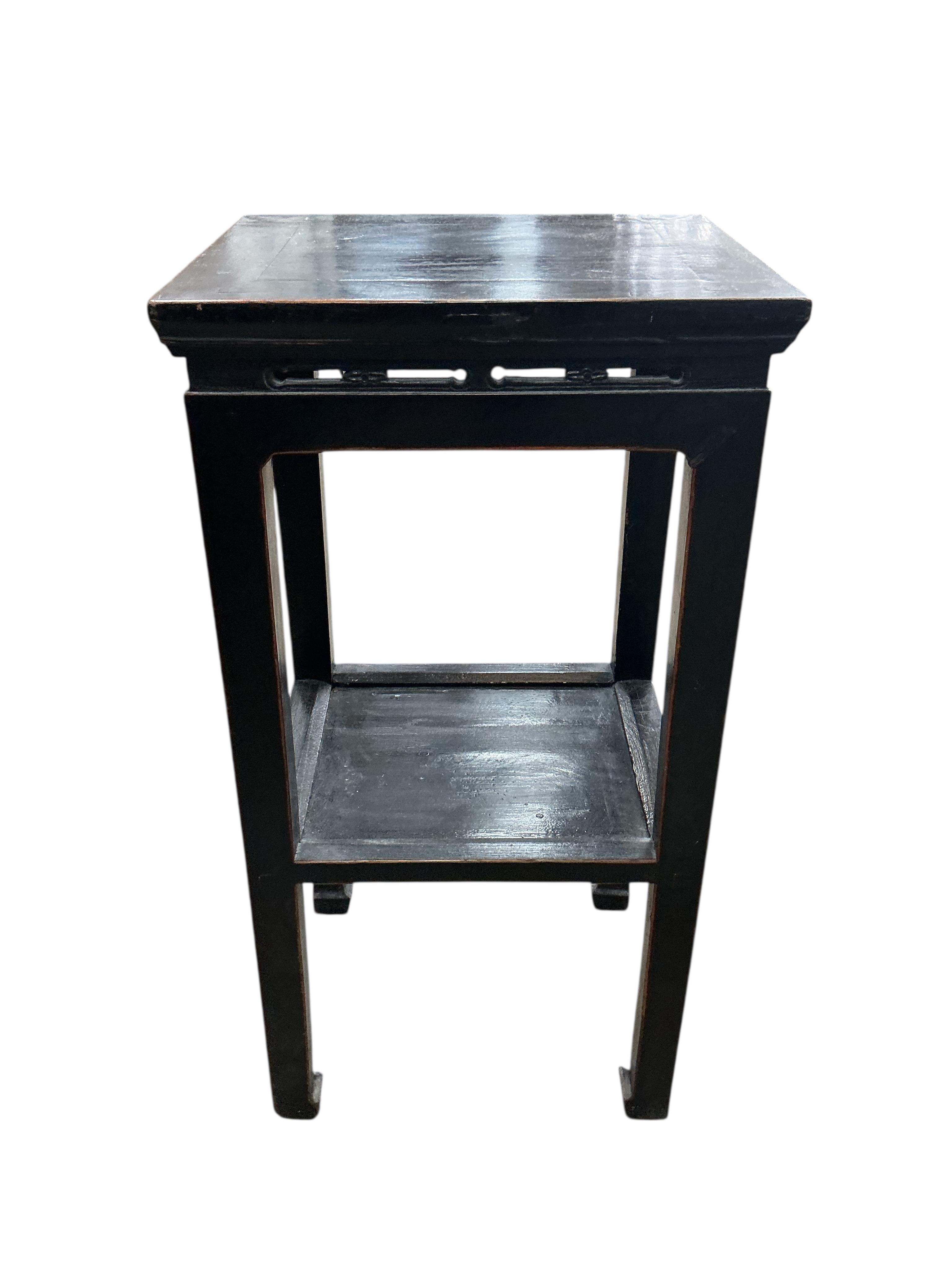 A pair of Chinese lacquer two tier tables, width 41cm, depth 34cm, height 79cm, Provenance: The late Kenneth Turner (1936-2025), celebrity florist, designer and perfume retailer, he received the Royal Warrant from the Pr